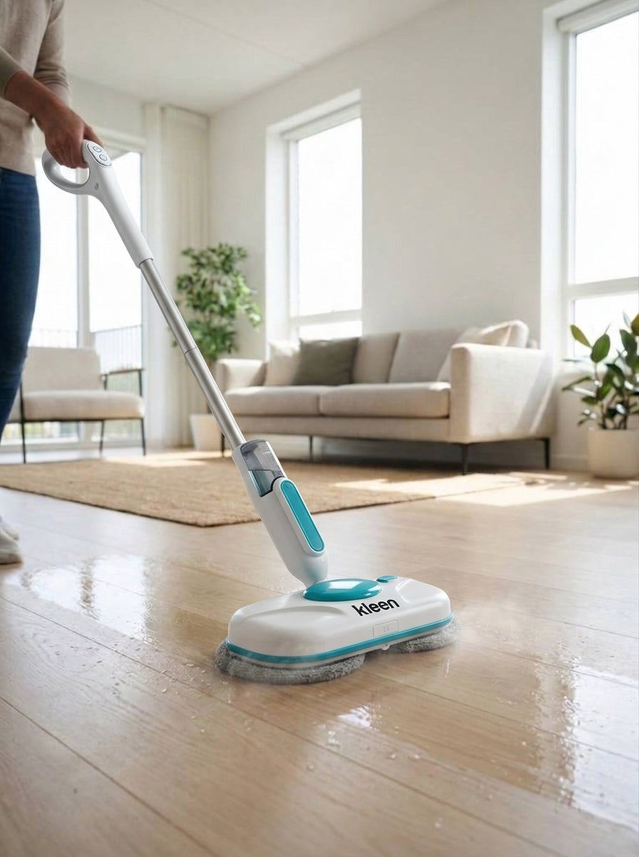 Person using the KleenMop electric spin mop on a hardwood floor in a bright living room